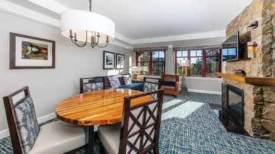 a living room with a table and a fireplace at Marriott Timber Lodge 1BR Apartment with Resort Access in South Lake Tahoe