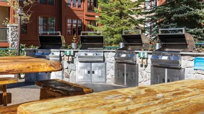 a row of barbecue stoves on a patio at Marriott Timber Lodge 2BR Apartment with Resort Access in South Lake Tahoe