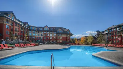 a large swimming pool in front of a building at Marriott Timber Lodge 3BR Apartment with Resort Access in South Lake Tahoe