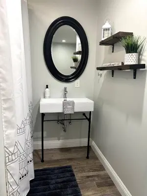 a bathroom with a sink and a mirror at Rustic Retreat 3 bd/2 bth - Large Family Game Area in Fresno
