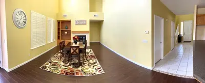 a hallway with a table and a clock on the wall at la paz private room with jacuzi in Fresno