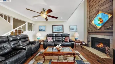 a living room with leather furniture and a fireplace at Waterfront Sleeps 6 near Marina with Hot Tub in Discovery Bay