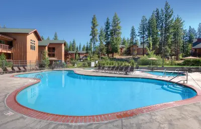 a large pool at a resort with chairs and trees at Wyndham South Shore 1BR Apartment with Resort Access in Zephyr Cove