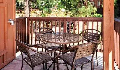 a table and four chairs on a porch with a table at Wyndham South Shore 1BR Apartment with Resort Access in Zephyr Cove