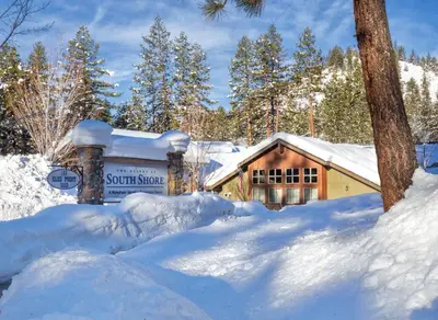 a sign in the snow in front of a cabin at Wyndham South Shore 2BR Apartment with Resort Access in Zephyr Cove