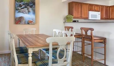 a kitchen with a wooden table and four chairs at Wyndham South Shore 3BR Apartment with Resort Access in Zephyr Cove