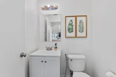 a bathroom with a white toilet and a sink at Elegant Retreat- Sleep 10-Boho Dome Lounge-Hot Tub-Games-Golf-Serene Getaway in Sacramento