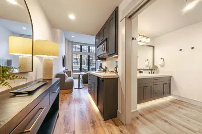 a large kitchen with a sink and a mirror at Catamount Lodge 101A by East West Hospitality in Truckee