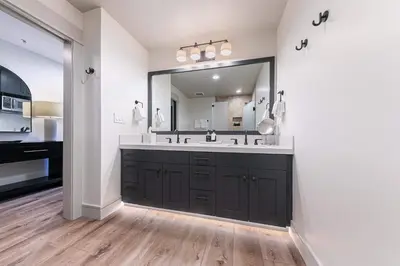 a bathroom with a large sink and a large mirror at Catamount Lodge 101A by East West Hospitality in Truckee