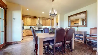 a kitchen and dining room with a wooden table and chairs at Snowcreek VI The Lodges #1197 condo in Mammoth Lakes