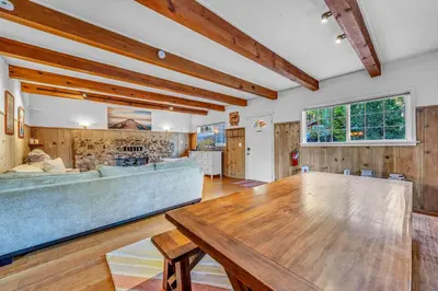 a living room with a table and a couch at Tahoe City Gem Pet Friendly Yard Walk to Beach in Tahoe City
