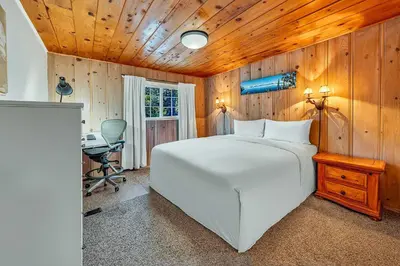 a bedroom with a large white bed and a desk at Tahoe City Gem Pet Friendly Yard Walk to Beach in Tahoe City