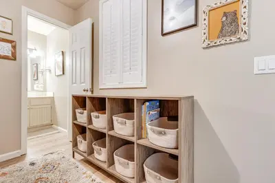 a room with a book shelf with baskets at Stroll to The Village Year-Round Family Getaway in Mammoth Lakes