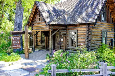 a log cabin with flowers in front of it at Unit 18B at Granlibakken in Tahoe City
