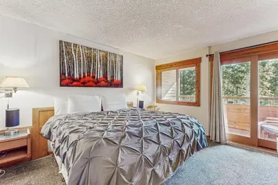 a bedroom with a bed and a window at Unit 18B at Granlibakken in Tahoe City