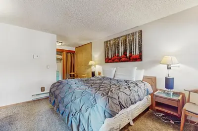 a bedroom with a bed and a painting on the wall at Unit 18B at Granlibakken in Tahoe City