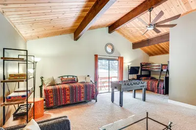 a bedroom with two beds and a table at Cabin Getaway Near Big Trees Park Game Room, Deck in Camp Connell