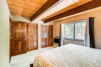 a bedroom with a bed and a large window at Cabin Getaway Near Big Trees Park Game Room, Deck in Camp Connell