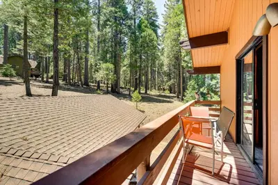 a wooden deck with a chair on top of it at Cabin Getaway Near Big Trees Park Game Room, Deck in Camp Connell