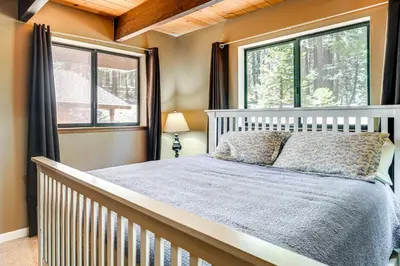 a bedroom with a bed and two windows at Cabin Getaway Near Big Trees Park Game Room, Deck in Camp Connell