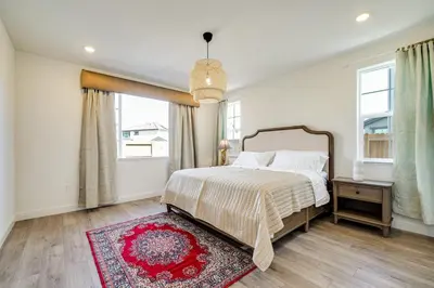 a bedroom with a bed and a red rug at 4 Mi to San Joaquin River Manteca Home with Patio! in Manteca