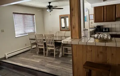 a kitchen with a dining room table and chairs at Heavenly Valley Townhouses in South Lake Tahoe