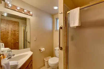 a bathroom with a sink and a toilet and a mirror at Heavenly Valley Townhouses in South Lake Tahoe