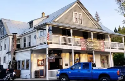 a blue truck parked in front of a house at Georgetown Hotel and Saloon in Georgetown