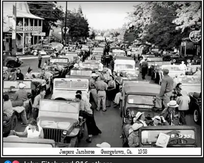 a black and white photo of a crowd of cars at Georgetown Hotel and Saloon in Georgetown