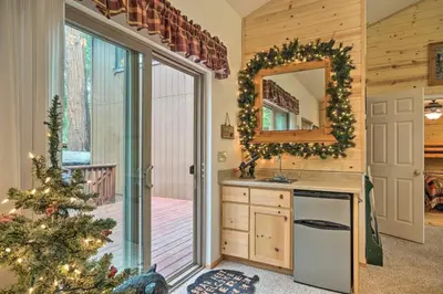 a kitchen with a christmas tree and a mirror at Game Room and Deck Pet-Friendly Camp Connell Cabin in Camp Connell