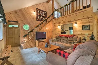 a living room with two couches and a tv at Game Room and Deck Pet-Friendly Camp Connell Cabin in Camp Connell