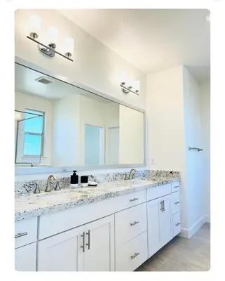 a bathroom with two sinks and a large mirror at Cozy Private master bedroom in a single family house in Elk Grove