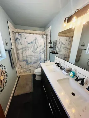 a bathroom with a sink and a toilet and a mirror at Family Fun-Dogs ok-Bass lake-Yosemite-Sleeps 8 in Oakhurst