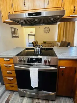 a kitchen with a stove with a tea pot on it at Family Fun-Dogs ok-Bass lake-Yosemite-Sleeps 8 in Oakhurst