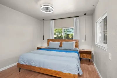 a bedroom with a large bed and a window at Yosemite+5BR+Views+Hot Tub+Pets in Coarsegold