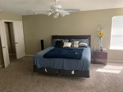 a bedroom with a bed and a ceiling fan at Furnished five bedroom and gated community in Patterson