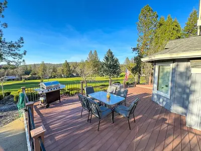 a deck with a table and chairs and a grill at On Golf Course, Family&Pet Friendly Yosemite Basecamp in Groveland