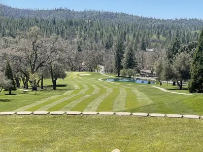 an aerial view of a golf course with a pond at On Golf Course, Family&Pet Friendly Yosemite Basecamp in Groveland