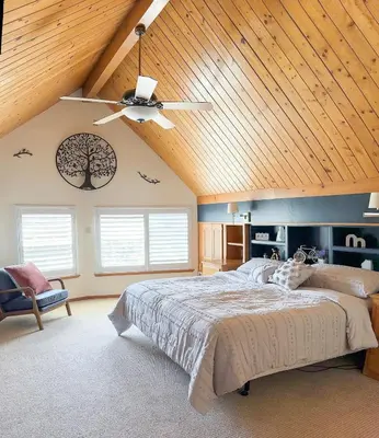 a bedroom with a large bed and a wooden ceiling at On Golf Course, Family&Pet Friendly Yosemite Basecamp in Groveland