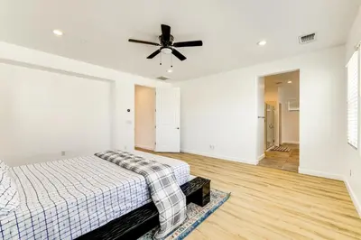 a bedroom with a bed and a ceiling fan at Walk to Parks Mountain House Retreat with Patio! in Tracy