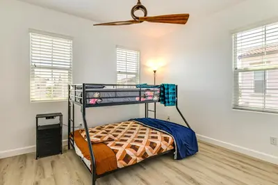 a bedroom with a bunk bed and a ceiling fan at Walk to Parks Mountain House Retreat with Patio! in Tracy