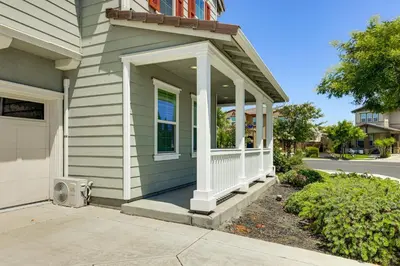a house with a porch with a white railing at Walk to Parks Mountain House Retreat with Patio! in Tracy