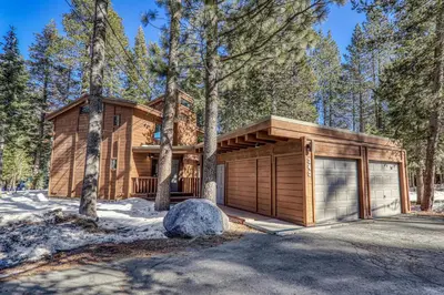 a house in the woods with a garage at Front and Center at Palisades by Tahoe Getaways - 3BR, Walk to Palisades! in Olympic Valley