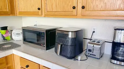 a microwave sitting on top of a kitchen counter at New - Spacious, Comfortable 5 Beds 3 Baths House in Elk Grove