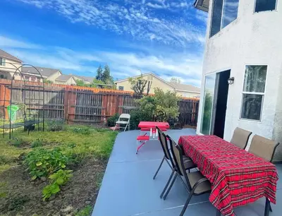 a patio with a red table and chairs on a patio at New - Spacious, Comfortable 5 Beds 3 Baths House in Elk Grove