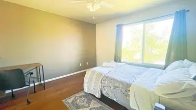 a bedroom with a bed and a window at New - Spacious, Comfortable 5 Beds 3 Baths House in Elk Grove
