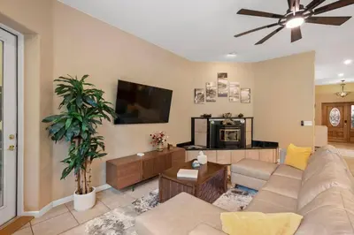 a living room with a couch and a flat screen tv at Stylish 6 Bdr home, GameRoom, near Lake | Yosemite in Groveland