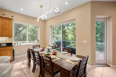 a kitchen and dining room with a table and chairs at Stylish 6 Bdr home, GameRoom, near Lake | Yosemite in Groveland