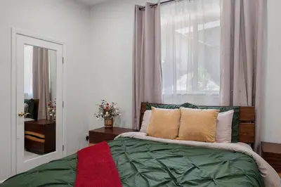 a bedroom with a green bed with a window at Stylish 6 Bdr home, GameRoom, near Lake | Yosemite in Groveland