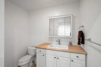 a bathroom with a sink and a toilet and a mirror at Stylish 6 Bdr home, GameRoom, near Lake | Yosemite in Groveland